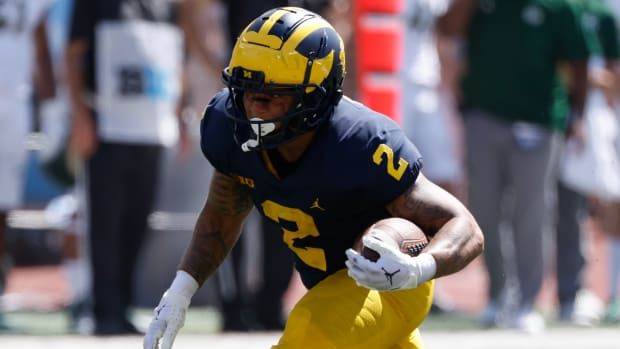 Michigan Wolverines running back Blake Corum on a rushing attempt during a college football game in the Big Ten.